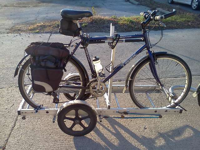 side view of a bicycle on a 64A Bikes At Work trailer, held in place using the plywood rack accessory