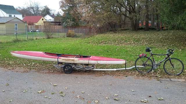 kayak on a trailer pulled by a bike