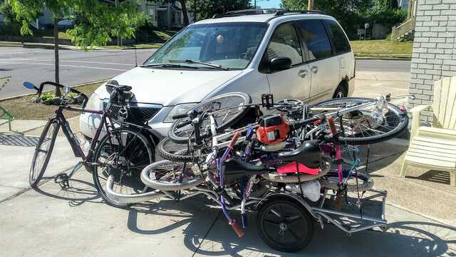 bike pulling trailer with bikes piled on it